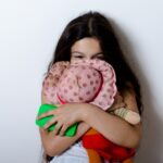 ぬいぐるみをハグする子ども